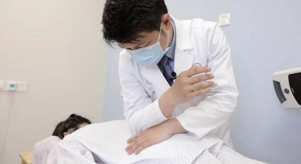 Jiahui physician performing a bedside examination on an inpatient