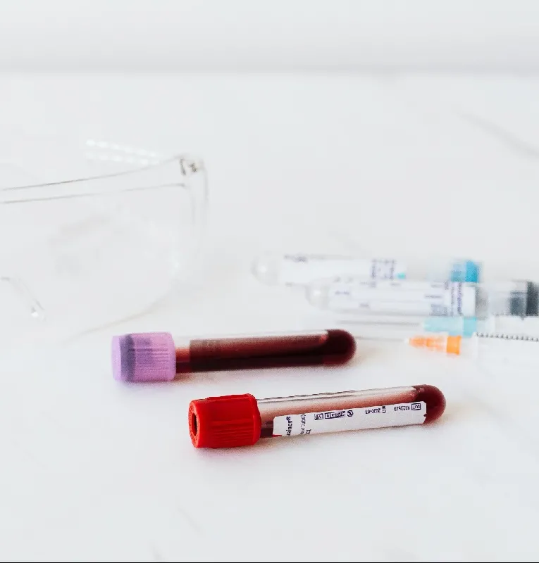 Blood collection tubes and syringes on a table, illustrating cardiac marker and troponin blood tests used to diagnose a heart attack